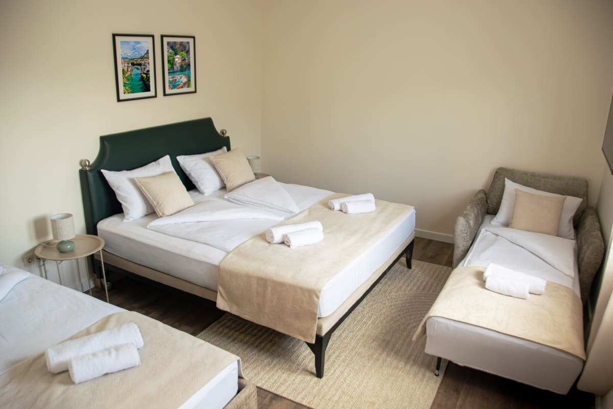 Mediterranean Deluxe Room — spacious boutique suite with elegant seating area